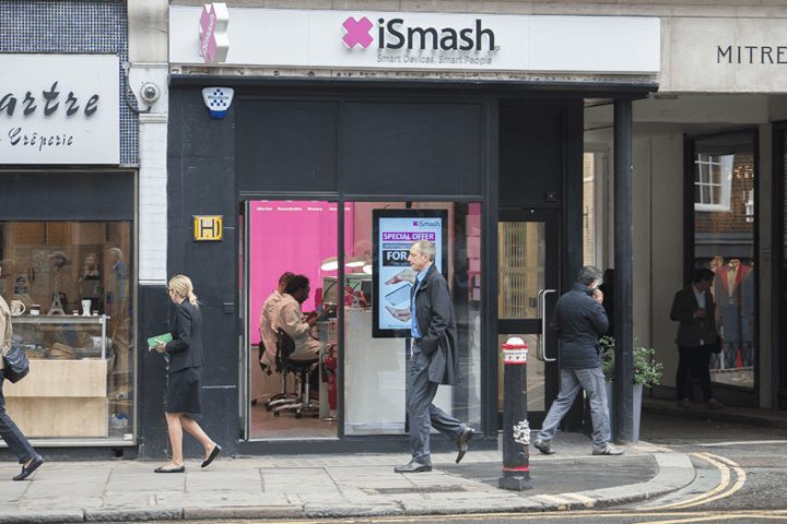 The exterior of iSmash's fleet street repair store with pedestrians walking