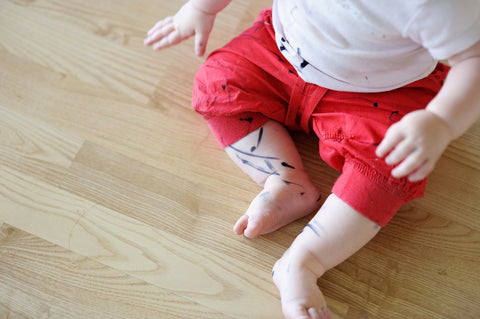 toddler with marker stains on his pants