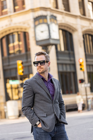 Man wearing Mr. 3 AM Stories sunglasses By Anna-Karin Karlsson walking the streets of downtown Tulsa