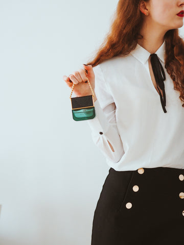 Woman holding green perfume