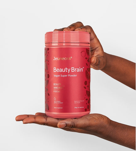 Woman holding up Beauty Brain Super Powder