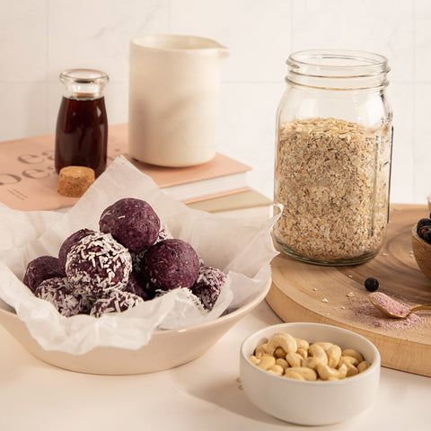 Kitchen set up with blackcurrant and coconut bliss balls using Jeuneora Beauty Brain