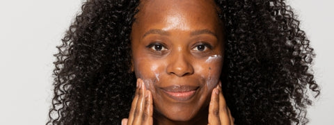 Woman using moisturiser on face in skincare routine