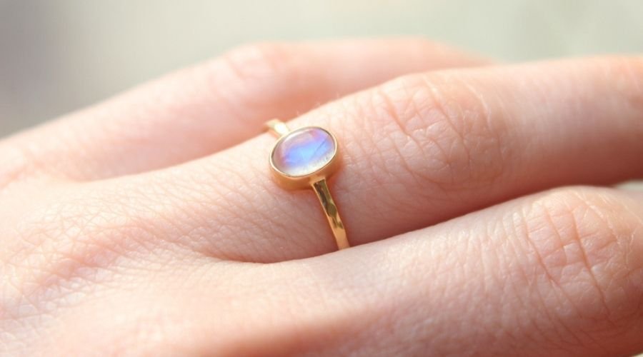 Opal engagement ring is not white anymore? I know that opal turns clear  when wet/humid but it is not, I cleaned it with water and a soft toothbrush  and it did nothing :
