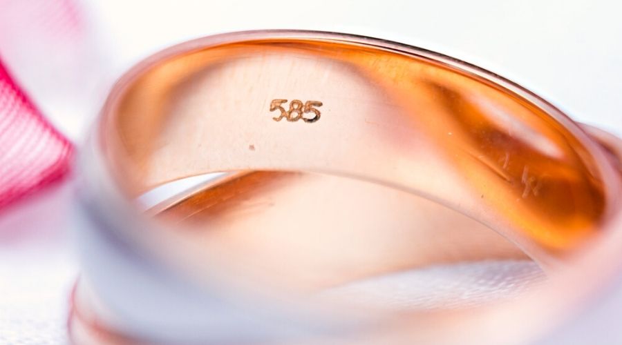 Close-up of a 585 hallmark on a gold ring