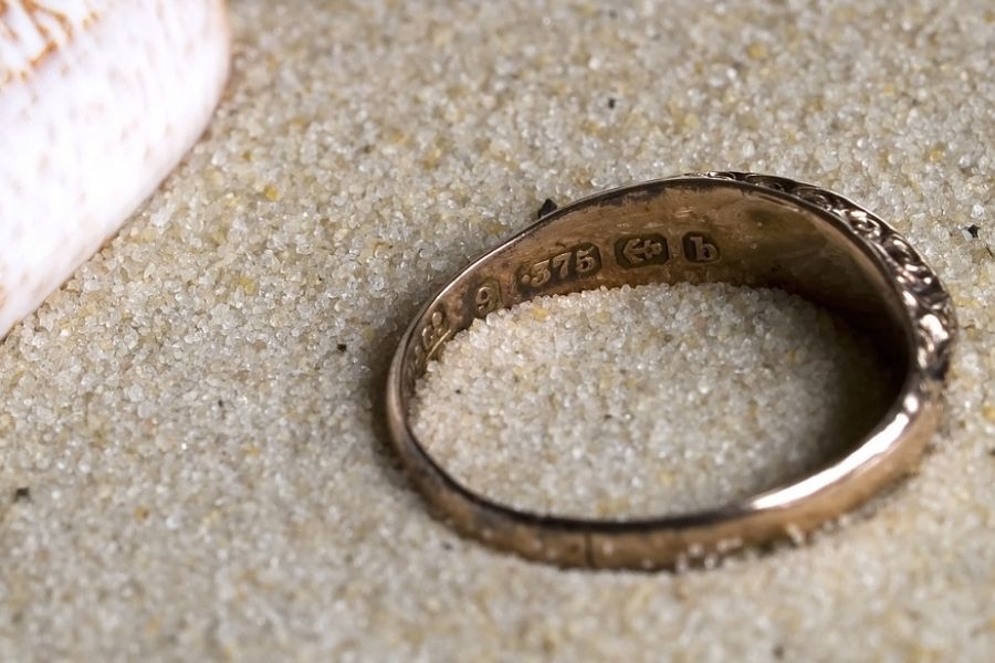 9 ct gold ring on the sand