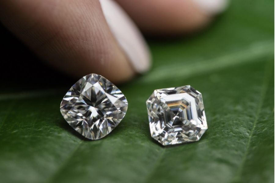 Asscher cut diamond and cushion cut diamond next to each other