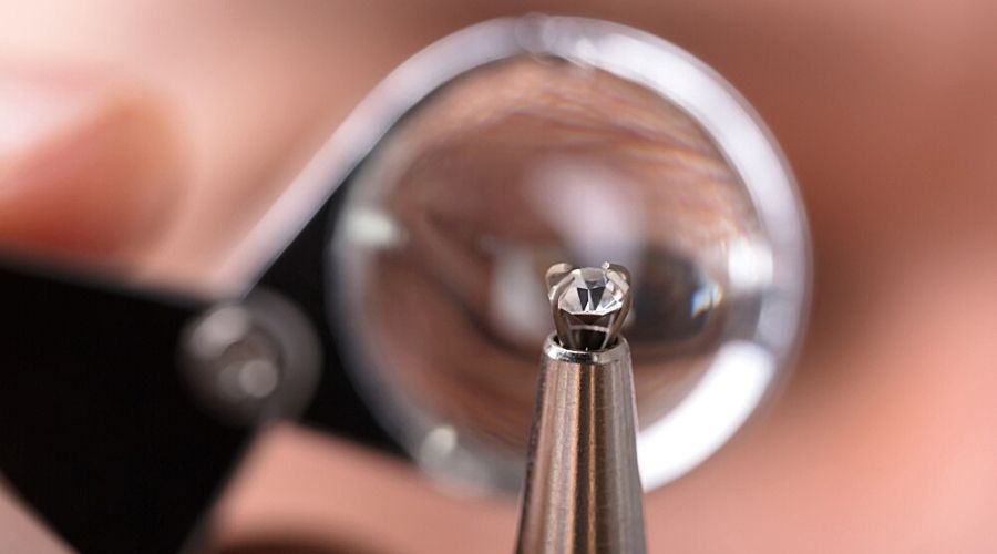 Close-up of a jeweler using a loupe to check the quality of a diamond