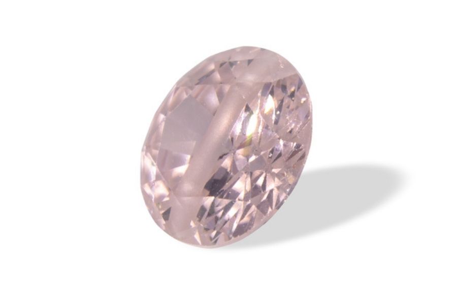 Faceted pink zircon on a white background.