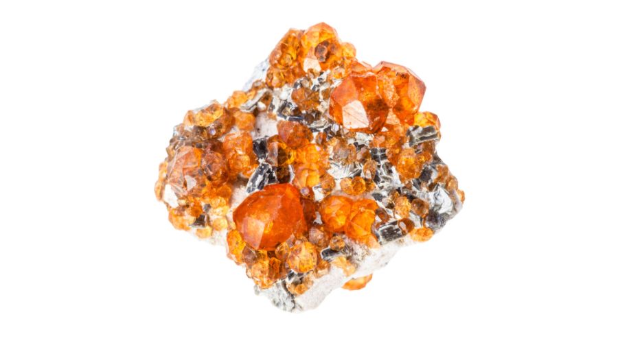 A raw spessartite garnet isolated against a white background