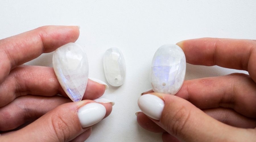 White Moonstones in a womans hands 