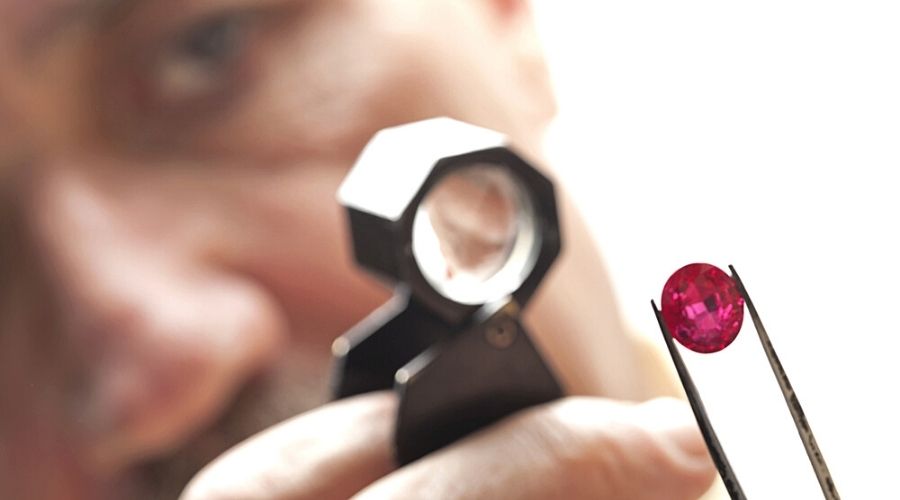 A gemologist checking a ruby's authenticity