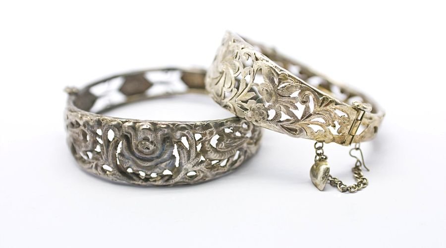 a pair of tarnished silver bracelets
