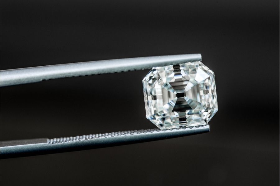 asscher cut diamond on tweezers