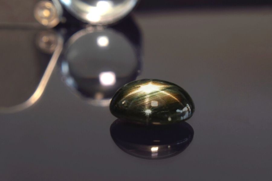 Black star sapphire on a black background.