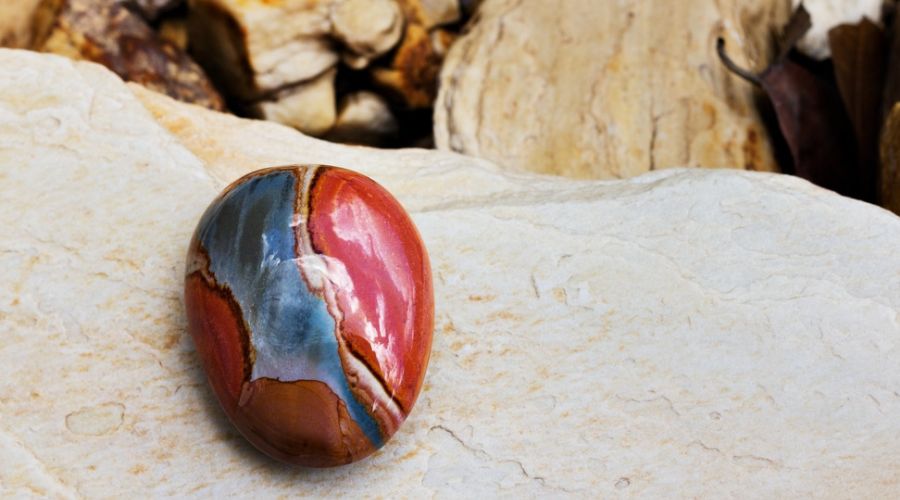 a red jasper stone with a hint of blue hue on one side