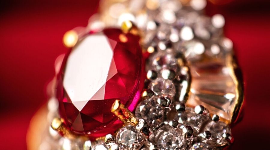 Close-up of a ruby set in a gold and diamond ring