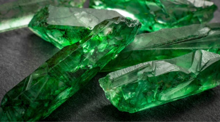 close up of raw uncut emeralds