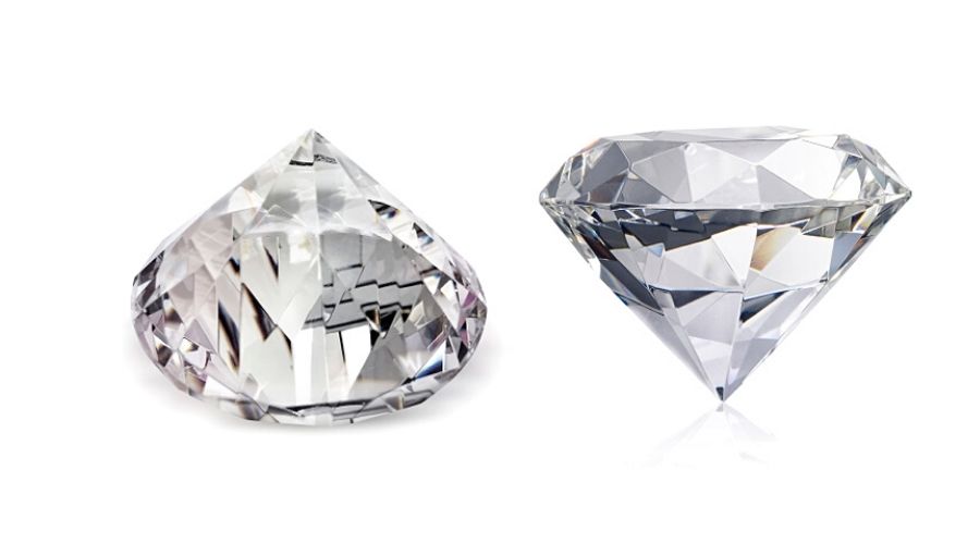 Two clear, faceted stones side-by-side and isolated on a white background
