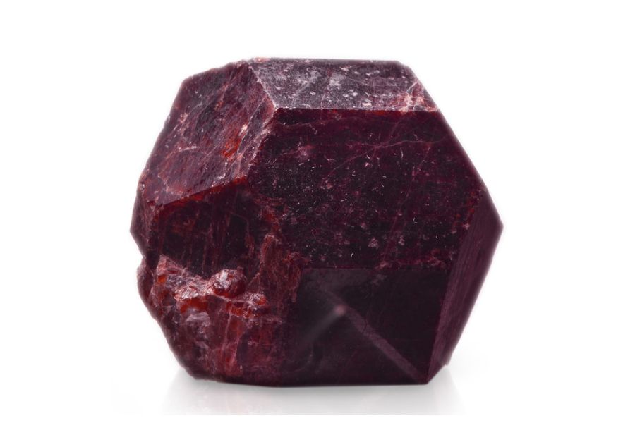 An unpolished garnet on a white background.