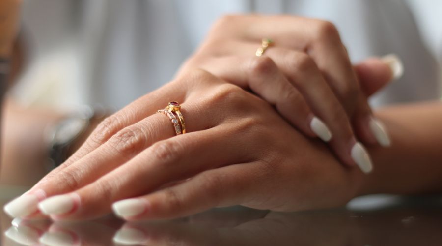 hands of a woman wearing gold rings