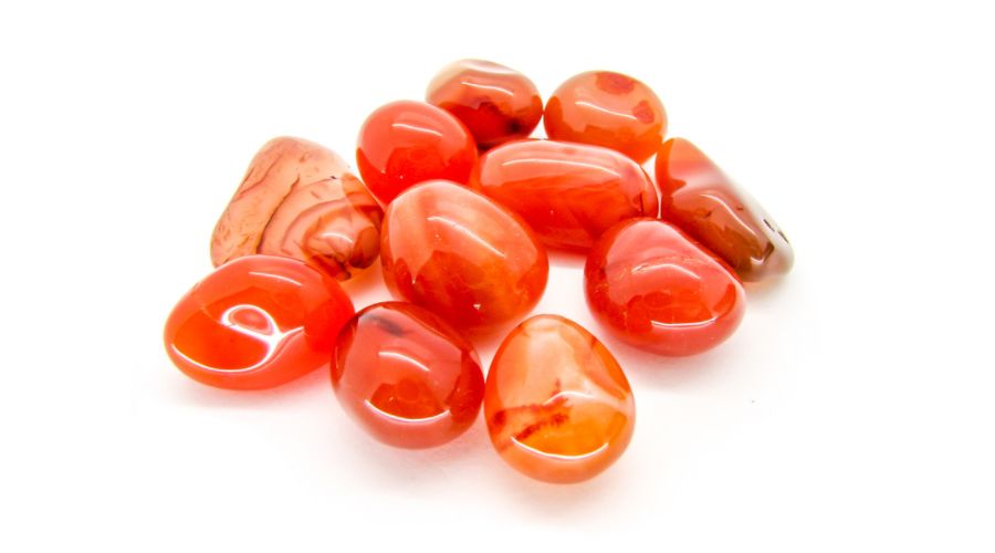 Orange carnelian stones isolated against a white background