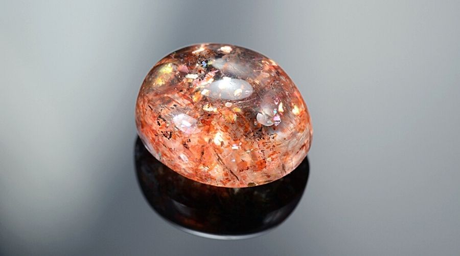 An Oregon sunstone isolated against a gray background