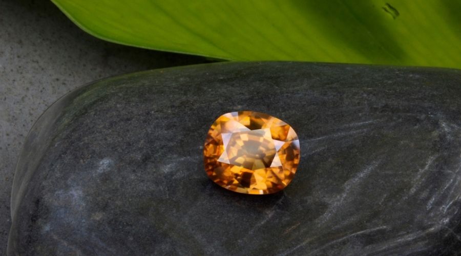 Orange zircon on a black stone