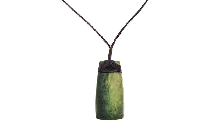 Greenstone necklace isolated against a white background