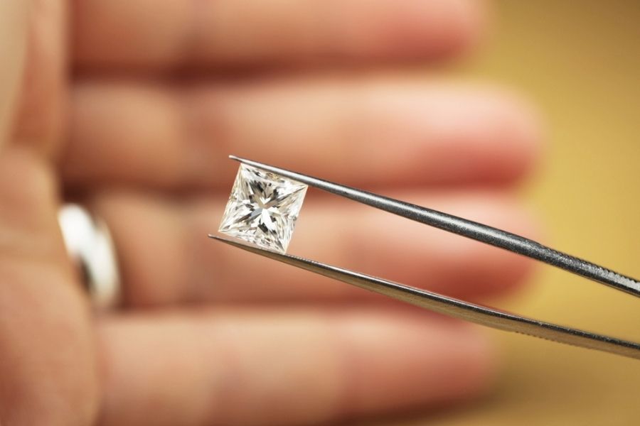 princess cut diamond on a tweezer