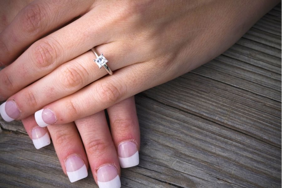 princess cut diamond ring on a woman's hand