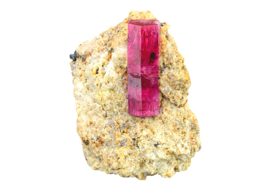 Red beryl stone on a white background.