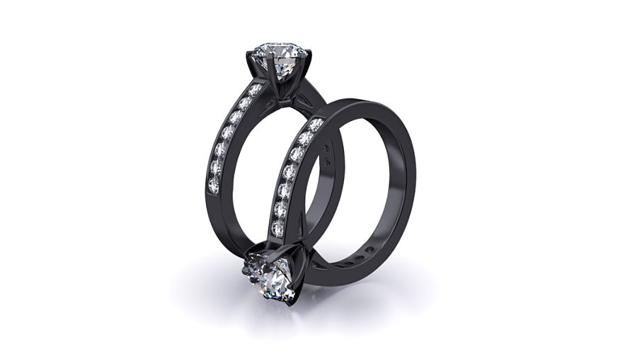 Two black gold diamond engagement rings on a white background