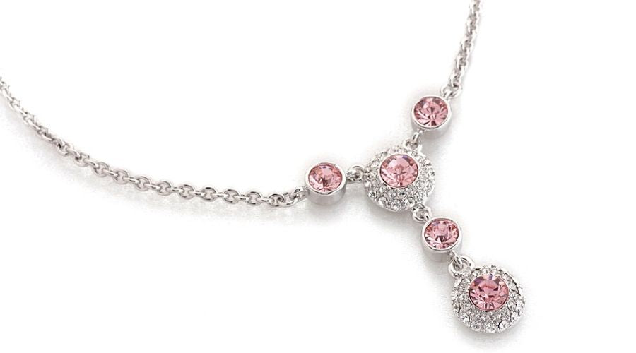 A white gold necklace embellished with pink diamonds on a white background