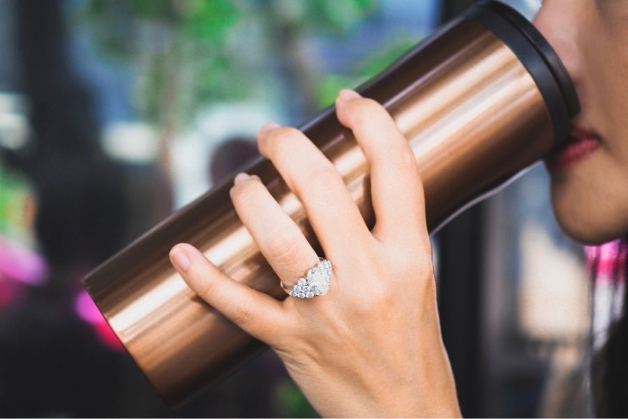 woman with a nice platinum ring drinking coffee