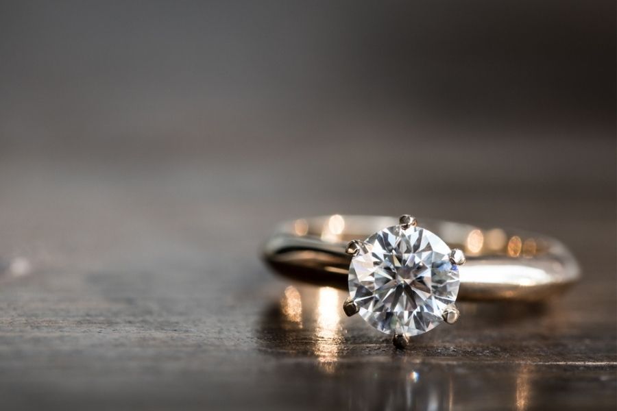 yellow gold diamond ring on wood table