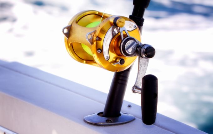 Picture of fishing rods and reels on a boat that is offshore