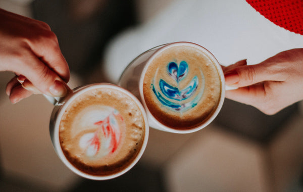 Person holding white ceramic mug