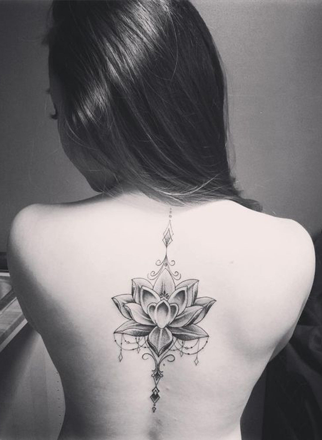 Mandala Lotus Flower Back Spine Tattoo Placement Ideas for Women at MyBodiArt.com
