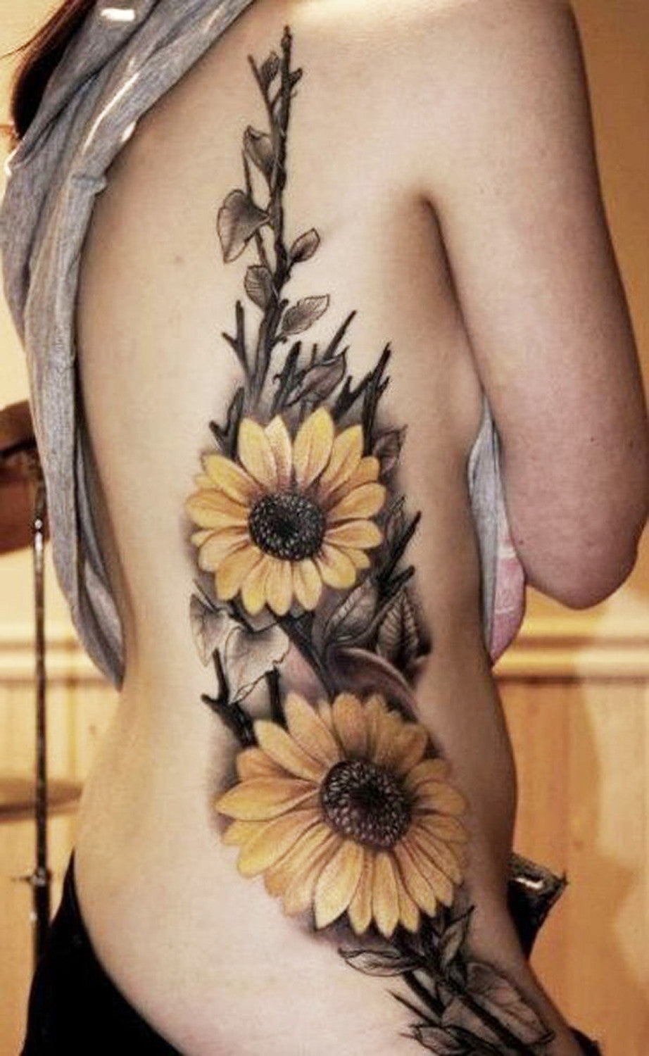 Realistic Colored Yellow  Sunflower Floral Flower Side Rib Tattoo Ideas for Women at MyBodiArt.com