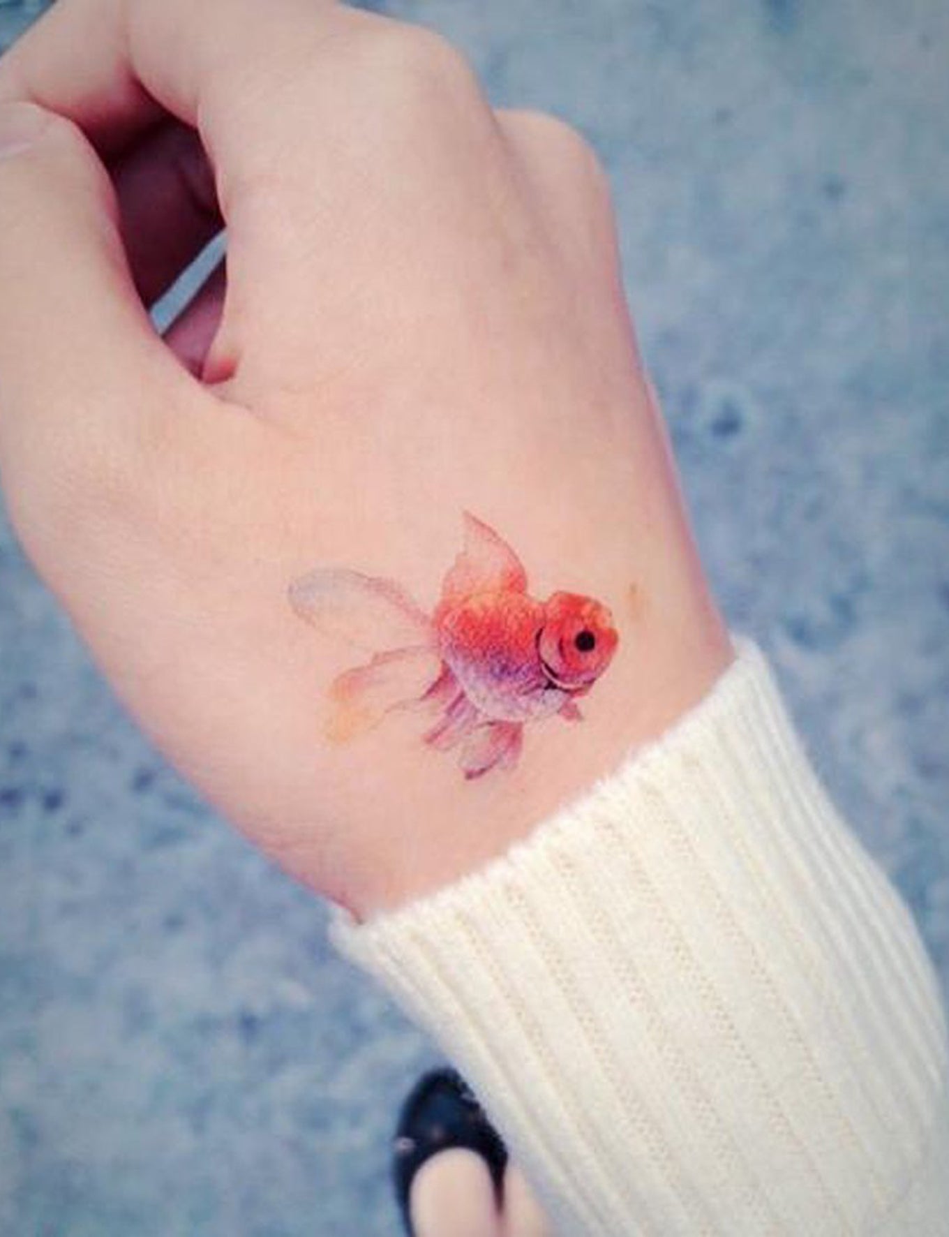 Small Simple Watercolor Goldfish Tattoo Ideas for Women at MyBodiArt.com