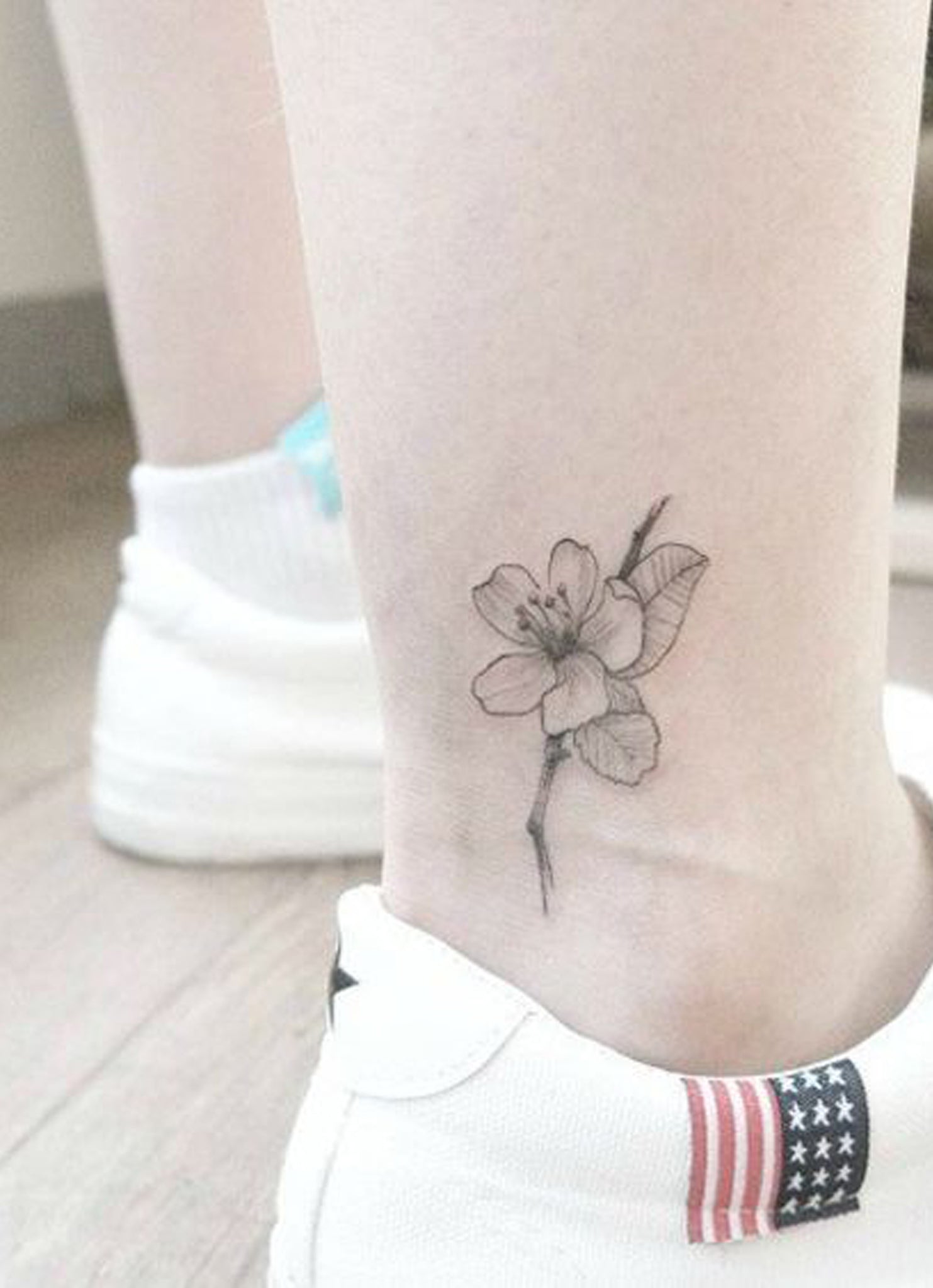 Delicate Black Cherry Blossom Ankle Tattoo Ideas for Women - Small Flower Leg Tat - www.MyBodiArt.com #tattoos