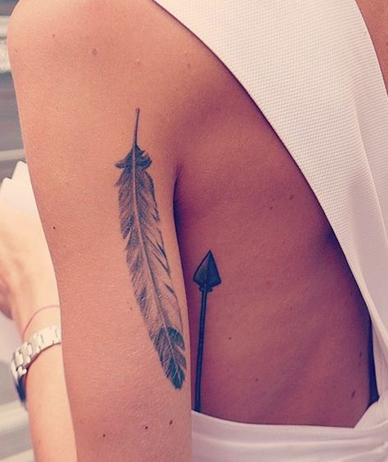 Back of Arm Feather - Womens Arrow Tattoo Ideas at MyBodiArt.com