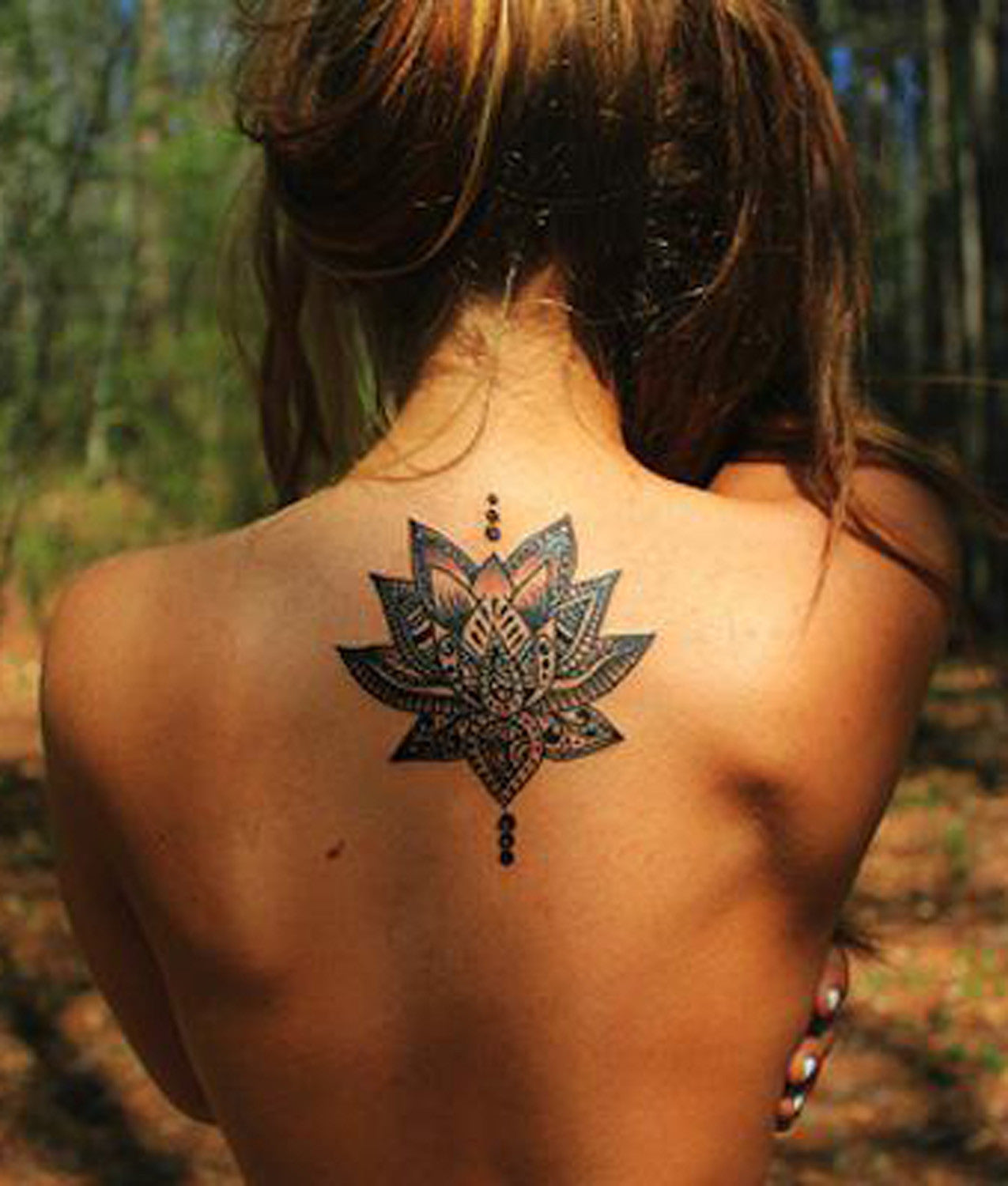 Tribal Lotus Upper Back Tattoo Ideas for Women at MyBodiArt.com