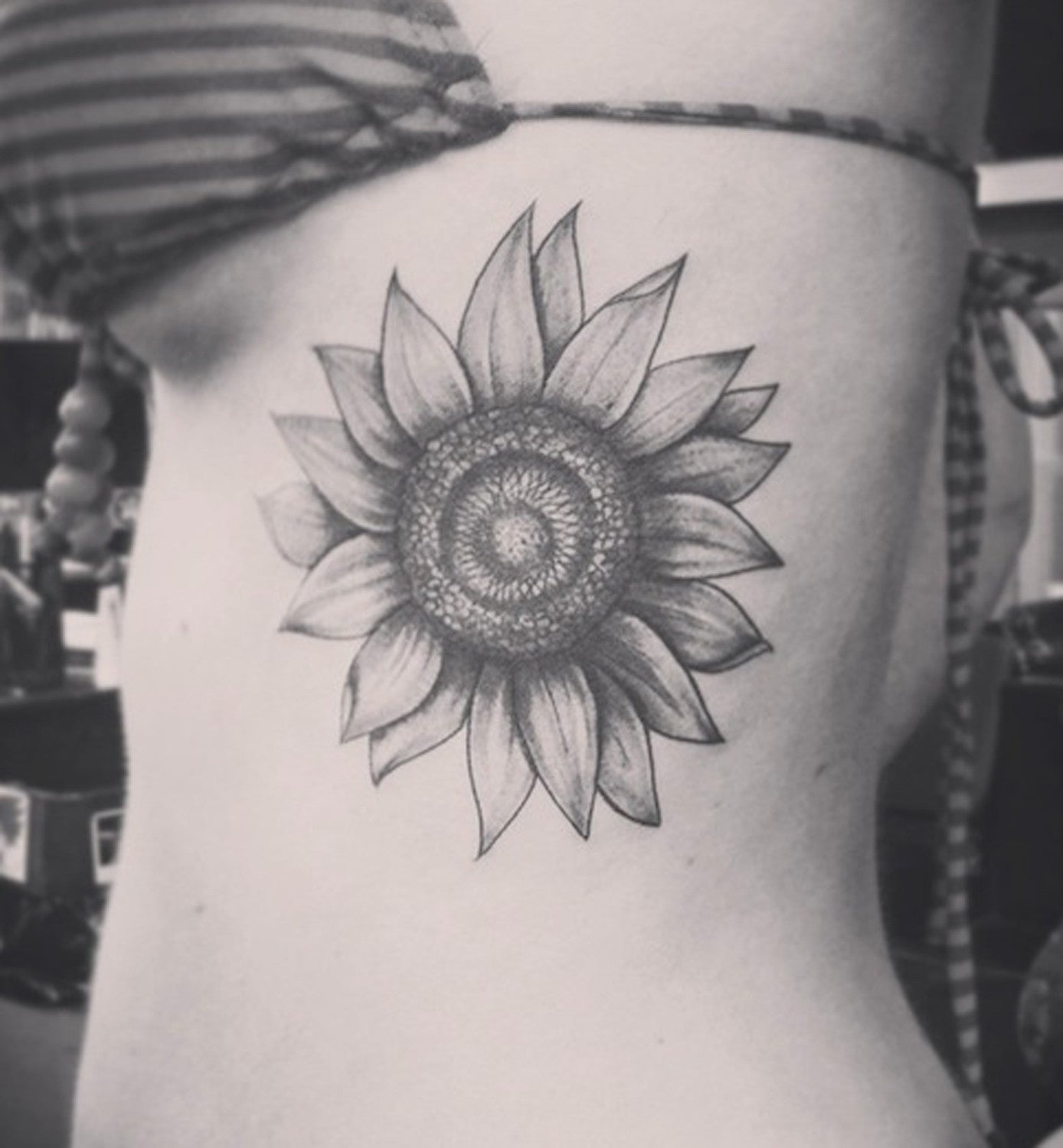 Realistic Large Black and White Sunflower Rib Tattoo Ideas for Women at MyBodiArt.com 