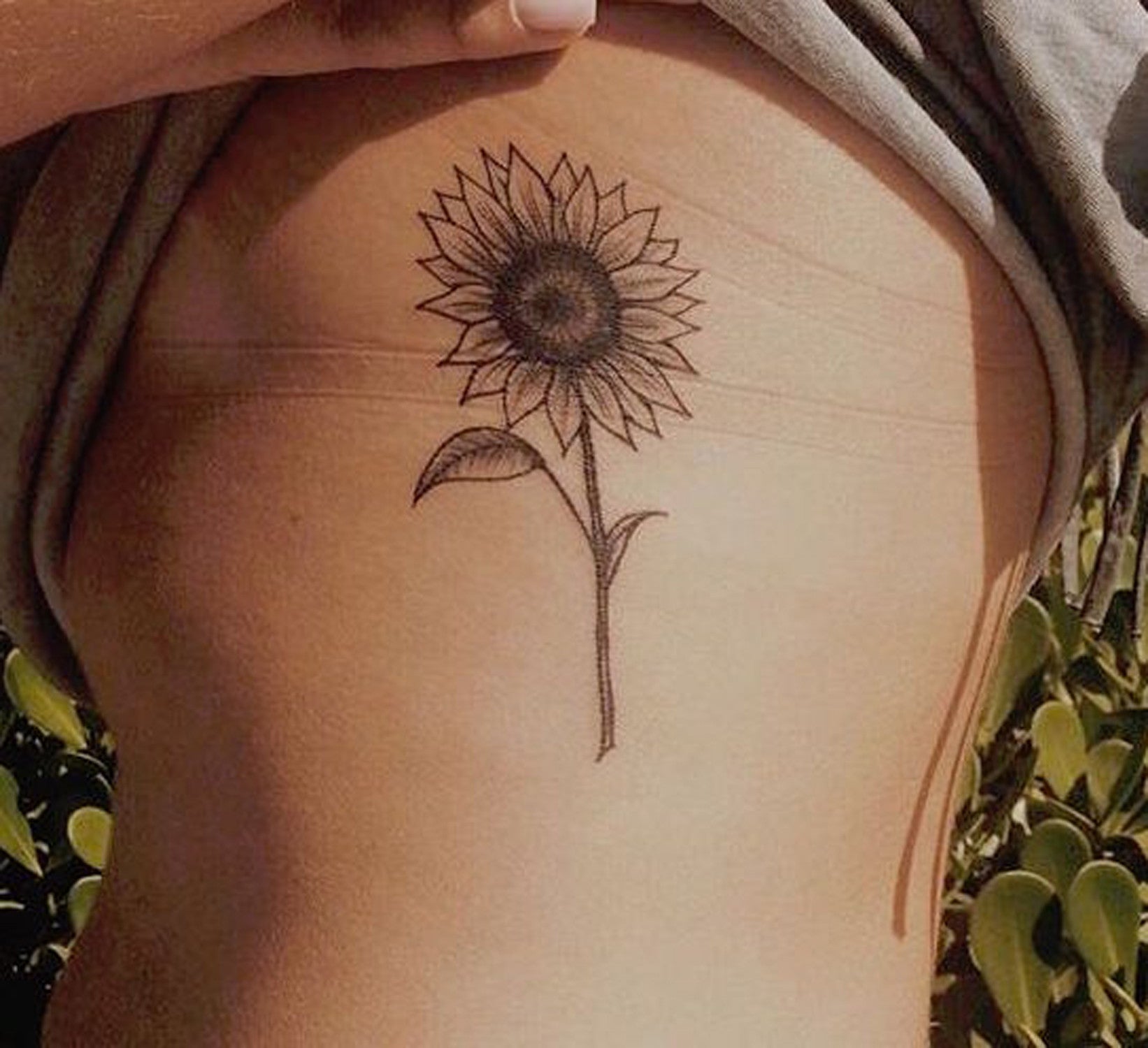 Simple Sunflower Side Boob Rib Tattoo Ideas for Women at MyBodiArt.com 