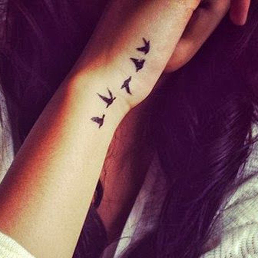 flying bird tattoo on wrist