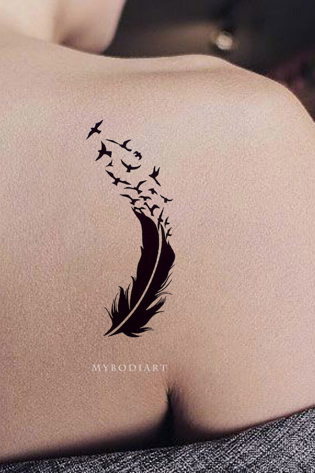 feather tattoo on hip bone