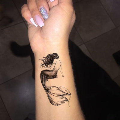 Single needle mermaid tattoo on the inner forearm