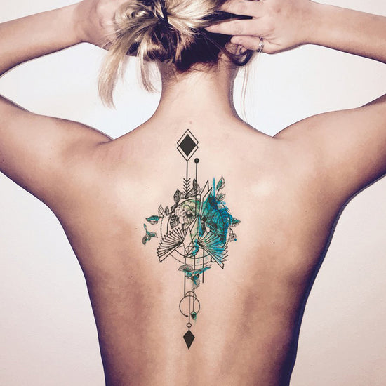 Bow and arrow tattoo located on the shoulder blade,